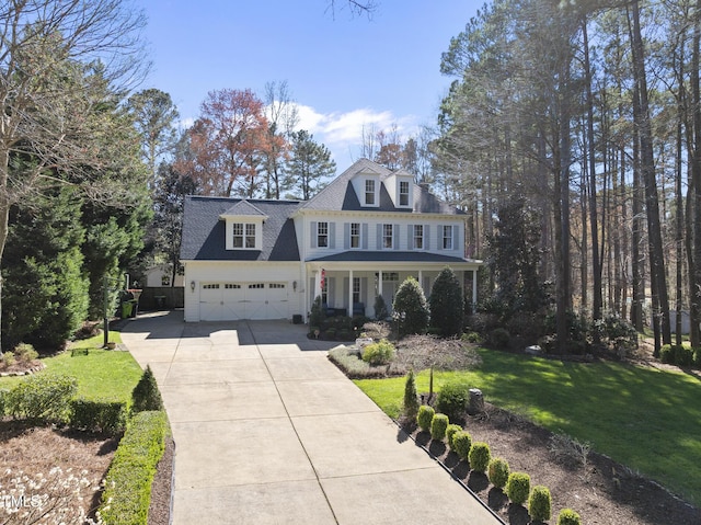 1006 Henny Pl, Raleigh, NC 27614 - view of front of house with covered porch, driveway, and a front lawn