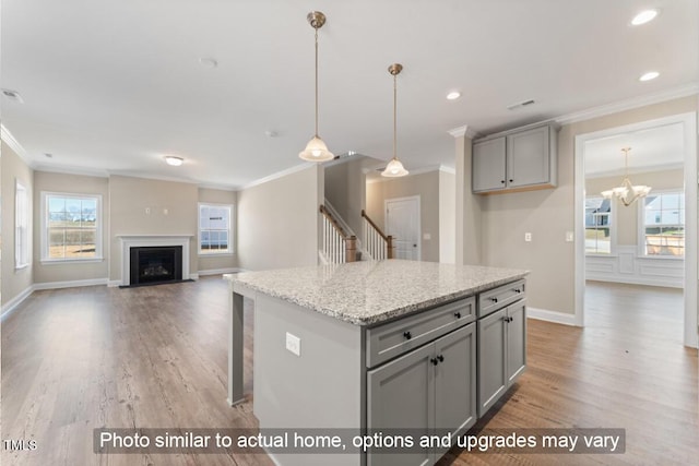 5504 Jaeger Dr Lot # 76, Graham, NC 27253 - kitchen featuring gray cabinets, crown molding, light wood-type flooring, plenty of natural light, and recessed lighting