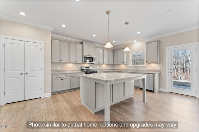 5504 Jaeger Dr Lot # 76, Graham, NC 27253 - kitchen with gray cabinetry, stainless steel appliances, crown molding, a sink, and a center island