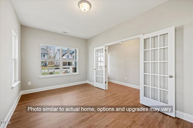 5504 Jaeger Dr Lot # 76, Graham, NC 27253 - empty room featuring french doors, wood finished floors, and baseboards