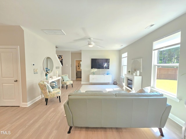1412 Queen Trigger Dr, Fuquay Varina, NC 27526 - living room featuring light wood-type flooring, baseboards, and ceiling fan