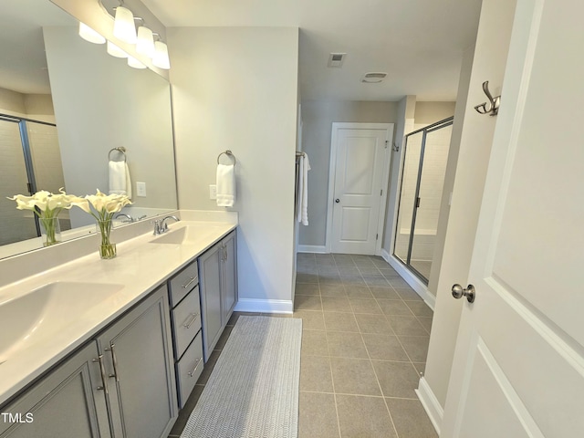 1412 Queen Trigger Dr, Fuquay Varina, NC 27526 - full bath featuring tile patterned flooring, double vanity, a stall shower, and baseboards