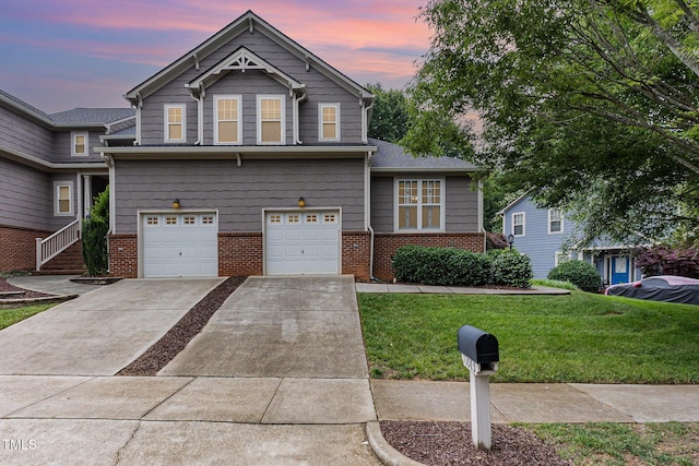 11005 Louson Pl, Raleigh, NC 27614 - view of front of house with brick siding, a yard, driveway, and a garage