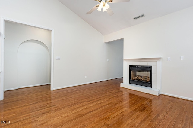 11005 Louson Pl, Raleigh, NC 27614 - unfurnished living room with a glass covered fireplace, ceiling fan, light wood-type flooring, high vaulted ceiling, and baseboards