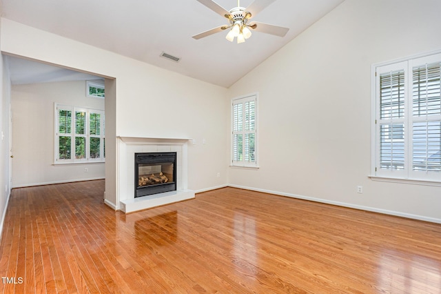 11005 Louson Pl, Raleigh, NC 27614 - unfurnished living room with a tile fireplace, light wood-type flooring, a ceiling fan, baseboards, and high vaulted ceiling