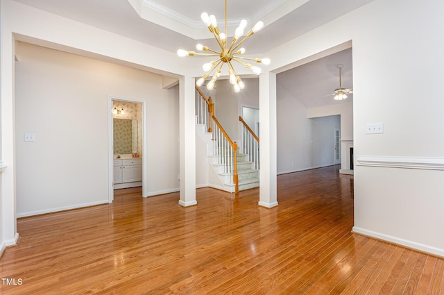 11005 Louson Pl, Raleigh, NC 27614 - spare room featuring ornamental molding, a chandelier, light wood finished floors, baseboards, and stairway