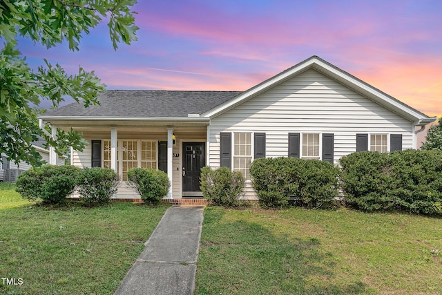 5437 Advantis Dr, Raleigh, NC 27610 - view of front of home with covered porch, a lawn, and a shingled roof