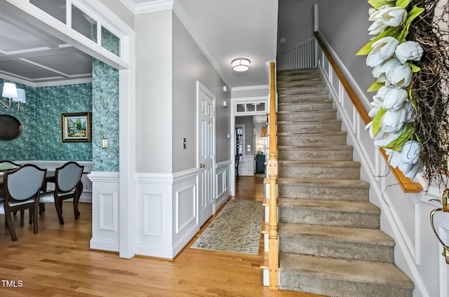 908 Town Side Dr, Apex, NC 27502 - stairs featuring wood finished floors, wainscoting, wallpapered walls, and crown molding