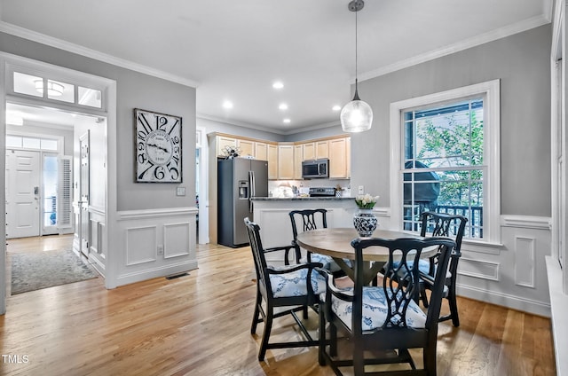 908 Town Side Dr, Apex, NC 27502 - dining room featuring crown molding, light wood-style flooring, a wainscoted wall, a decorative wall, and recessed lighting