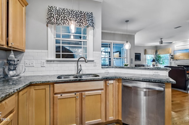 908 Town Side Dr, Apex, NC 27502 - kitchen with stainless steel dishwasher, a sink, crown molding, open floor plan, and dark stone countertops