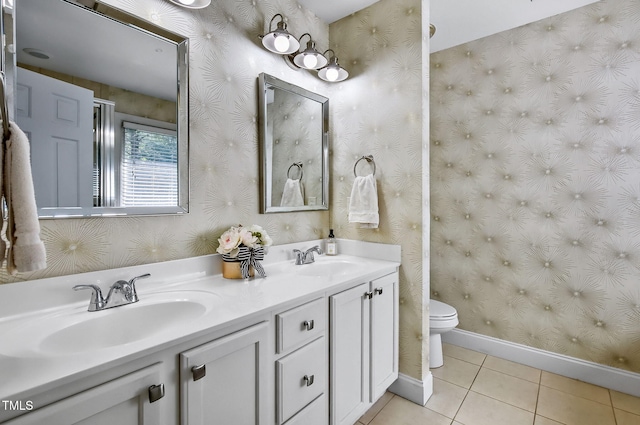 908 Town Side Dr, Apex, NC 27502 - bathroom with wallpapered walls, baseboards, toilet, double vanity, and tile patterned floors