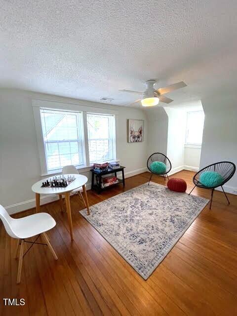 11609 US-401, Fuquay Varina, NC 27526 - living area with a textured ceiling, wood finished floors, baseboards, and a ceiling fan
