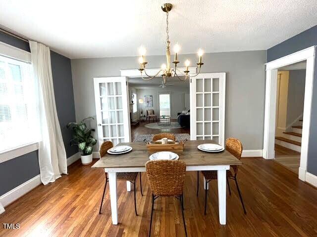 11609 US-401, Fuquay Varina, NC 27526 - dining room featuring a chandelier, wood finished floors, french doors, and baseboards
