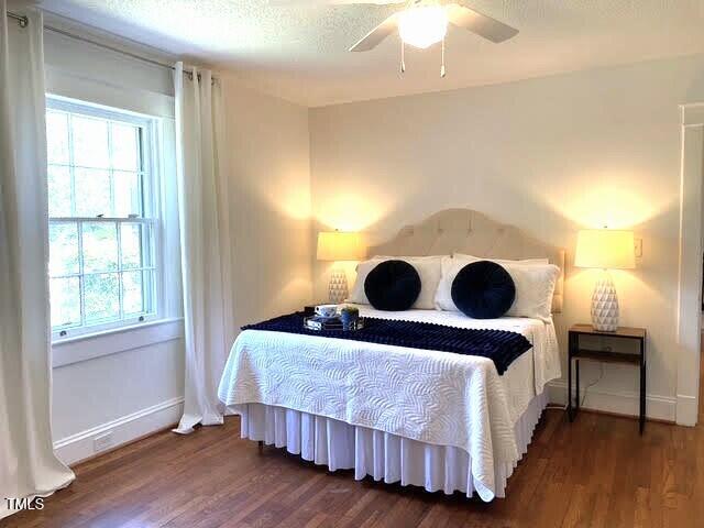 11609 US-401, Fuquay Varina, NC 27526 - bedroom with multiple windows, wood finished floors, baseboards, and a ceiling fan