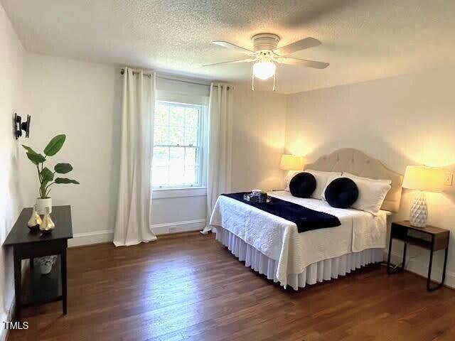 11609 US-401, Fuquay Varina, NC 27526 - bedroom with wood finished floors, baseboards, a textured ceiling, and a ceiling fan