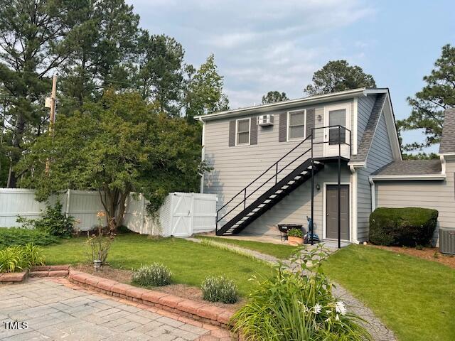 11609 US-401, Fuquay Varina, NC 27526 - rear view of house with stairway, central air condition unit, and a wall unit AC