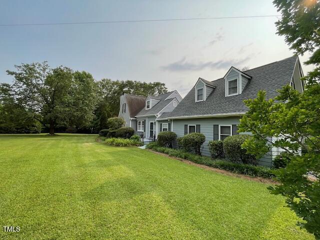 11609 US-401, Fuquay Varina, NC 27526 - view of front of home featuring a front yard and roof with shingles