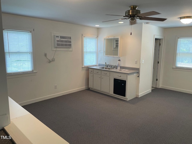 11609 US-401, Fuquay Varina, NC 27526 - kitchen with a sink, an AC wall unit, ceiling fan, dark colored carpet, and baseboards