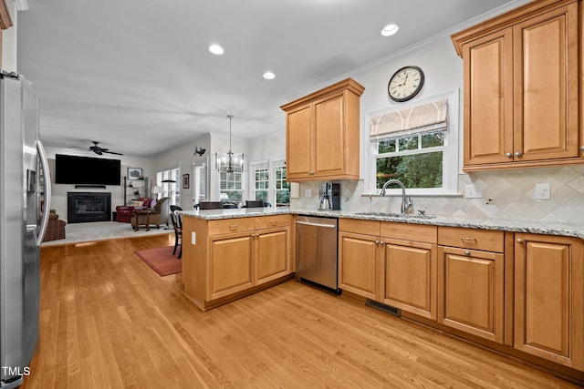 1412 Kings Lassiter Way, Raleigh, NC 27614 - kitchen with stainless steel appliances, a sink, open floor plan, light wood finished floors, and a peninsula