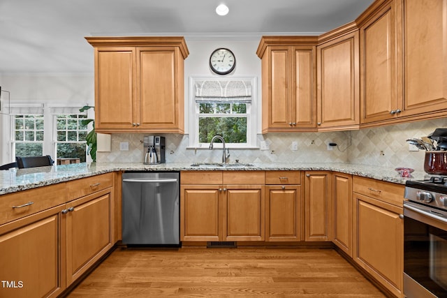 1412 Kings Lassiter Way, Raleigh, NC 27614 - kitchen with appliances with stainless steel finishes, a sink, crown molding, light wood-style flooring, and light stone counters