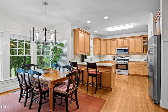 1412 Kings Lassiter Way, Raleigh, NC 27614 - kitchen with appliances with stainless steel finishes, a chandelier, a peninsula, crown molding, and light wood-type flooring