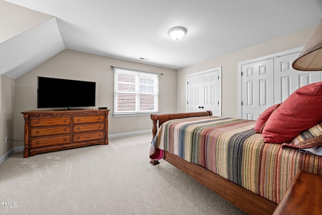 1412 Kings Lassiter Way, Raleigh, NC 27614 - carpeted bedroom featuring baseboards, two closets, and vaulted ceiling
