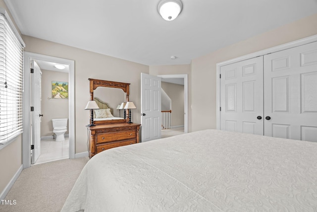 1412 Kings Lassiter Way, Raleigh, NC 27614 - carpeted bedroom with a closet, multiple windows, baseboards, and ensuite bathroom