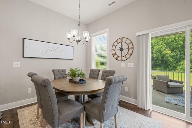 797 S Wilma St, Angier, NC 27501 - dining space featuring a chandelier, wood finished floors, baseboards, and lofted ceiling