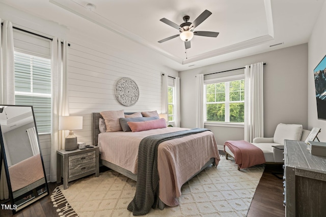 797 S Wilma St, Angier, NC 27501 - bedroom with light wood finished floors, a tray ceiling, and ceiling fan