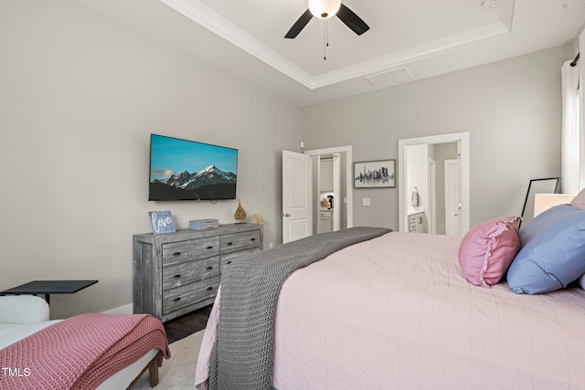 797 S Wilma St, Angier, NC 27501 - bedroom featuring wood finished floors, a raised ceiling, connected bathroom, and ceiling fan