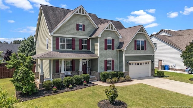 3024 Eagle Crest Ln, Fayetteville, NC 28306 - craftsman house featuring driveway, a porch, an attached garage, stone siding, and a shingled roof