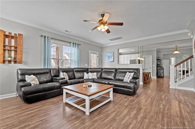 3024 Eagle Crest Ln, Fayetteville, NC 28306 - living room with a ceiling fan, wood finished floors, crown molding, stairs, and baseboards