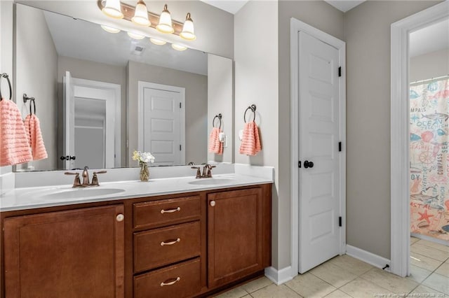 3024 Eagle Crest Ln, Fayetteville, NC 28306 - bathroom with double vanity, tile patterned flooring, and baseboards