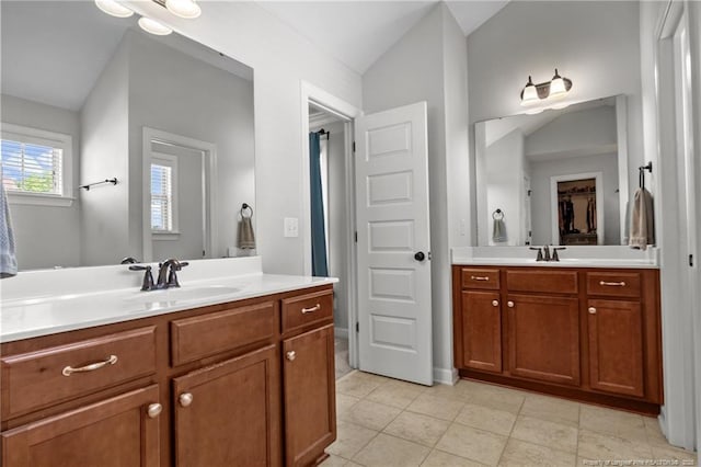 3024 Eagle Crest Ln, Fayetteville, NC 28306 - full bath featuring two vanities, vaulted ceiling, and tile patterned floors