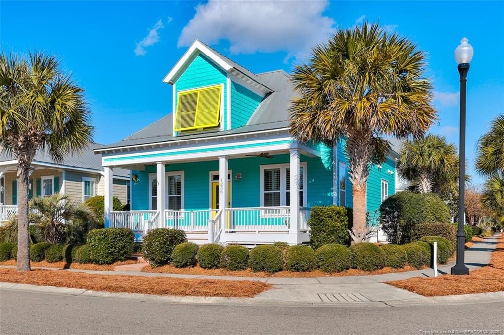 1236 Pinfish Ln, Carolina Beach, NC 28428 - view of front of house featuring covered porch and metal roof