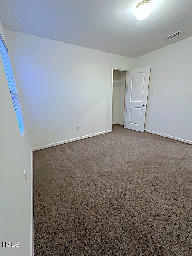 391 Curling Crk Dr, Clayton, NC 27527 - spare room featuring dark colored carpet and baseboards