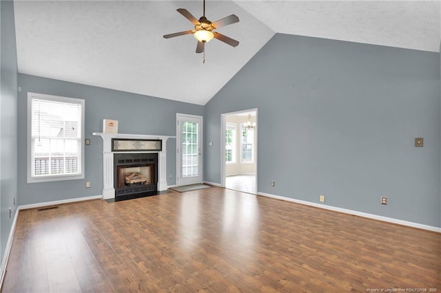 5533 Shady Pine Ct, Hope Mills, NC 28348 - unfurnished living room featuring ceiling fan, high vaulted ceiling, a fireplace with flush hearth, wood finished floors, and healthy amount of natural light