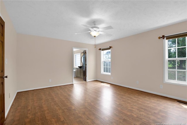 5533 Shady Pine Ct, Hope Mills, NC 28348 - spare room featuring healthy amount of natural light, wood finished floors, baseboards, and a textured ceiling