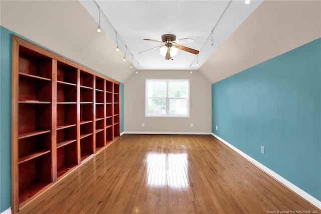 5533 Shady Pine Ct, Hope Mills, NC 28348 - spare room featuring rail lighting, a ceiling fan, baseboards, lofted ceiling, and hardwood / wood-style flooring