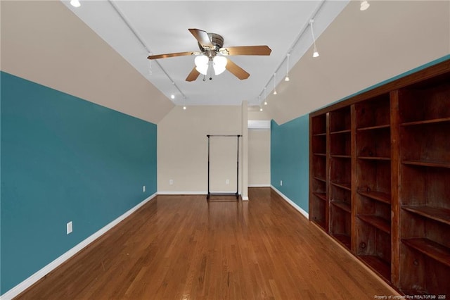 5533 Shady Pine Ct, Hope Mills, NC 28348 - unfurnished bedroom with rail lighting, lofted ceiling, wood finished floors, and baseboards