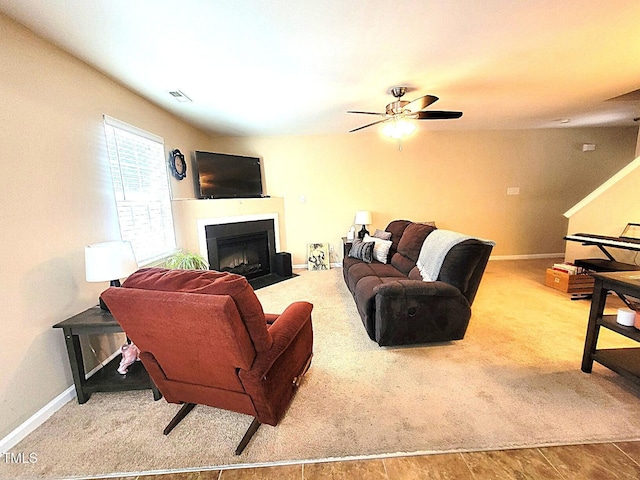 5126 Thornton Knoll Way, Raleigh, NC 27616 - carpeted living room with a fireplace with flush hearth and a ceiling fan