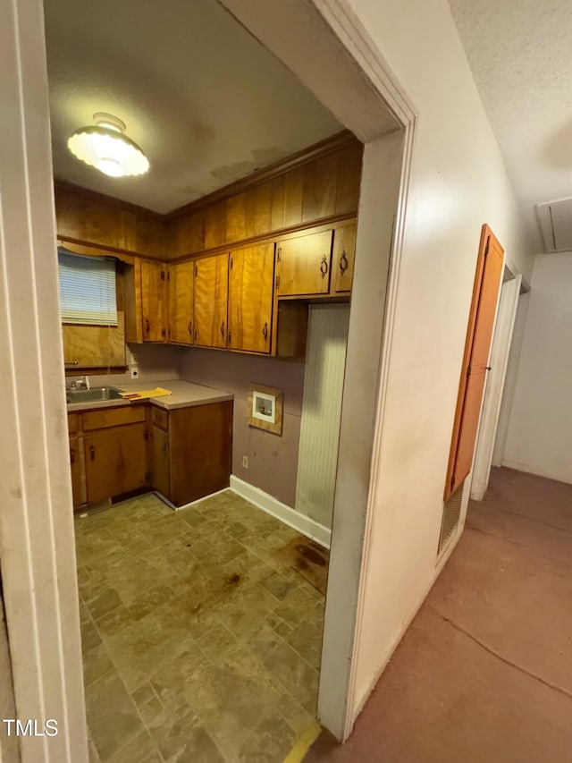 603 Pineland St, Sanford, NC 27330 - kitchen with brown cabinetry, a sink, and light countertops