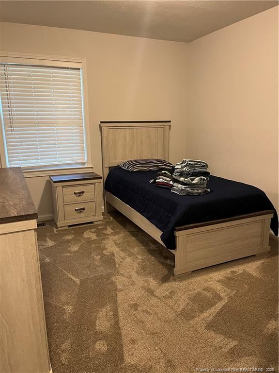 3914 Coventry Rd, Fayetteville, NC 28304 - bedroom featuring dark colored carpet and baseboards