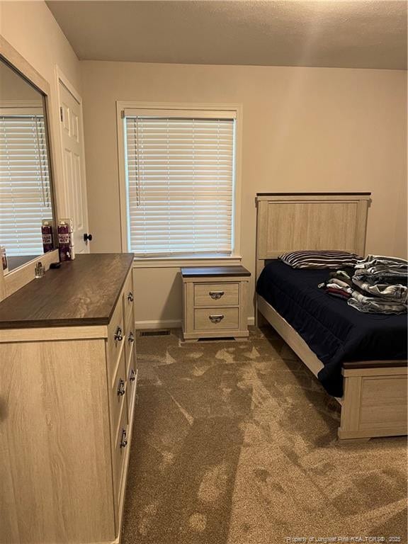 3914 Coventry Rd, Fayetteville, NC 28304 - bedroom featuring dark carpet and baseboards