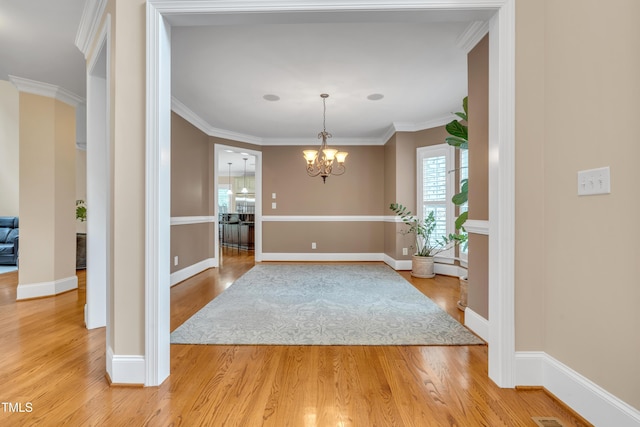 3004 Krogen Ct, Creedmoor, NC 27522 - unfurnished dining area with a chandelier, light wood-style flooring, baseboards, and crown molding