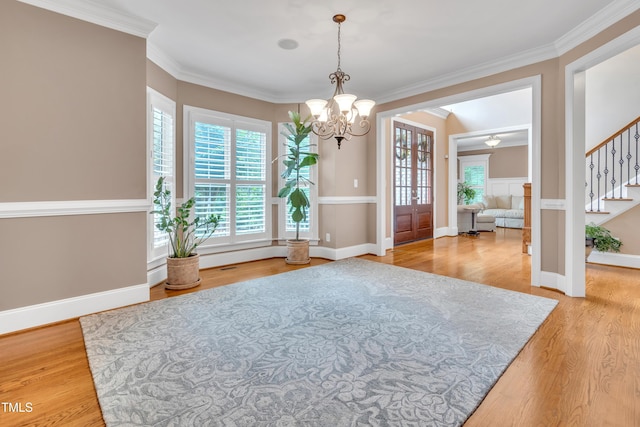 3004 Krogen Ct, Creedmoor, NC 27522 - unfurnished dining area with a chandelier, stairway, light wood finished floors, crown molding, and baseboards
