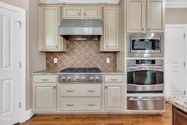 3004 Krogen Ct, Creedmoor, NC 27522 - kitchen with stainless steel appliances, cream cabinets, exhaust hood, and a warming drawer