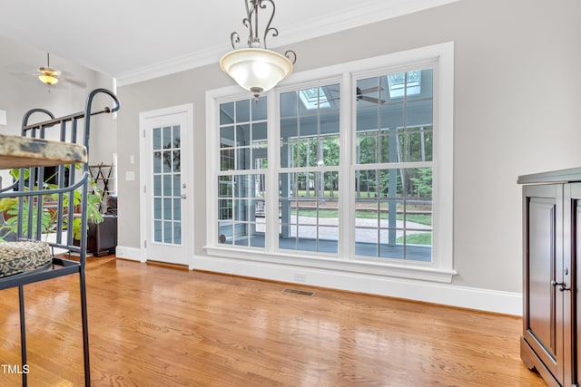 3004 Krogen Ct, Creedmoor, NC 27522 - unfurnished dining area featuring baseboards, ceiling fan, crown molding, and light wood-type flooring