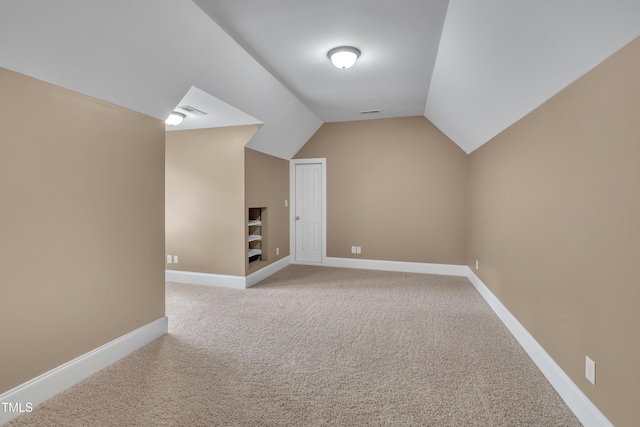 3004 Krogen Ct, Creedmoor, NC 27522 - additional living space with light carpet, vaulted ceiling, baseboards, and built in shelves