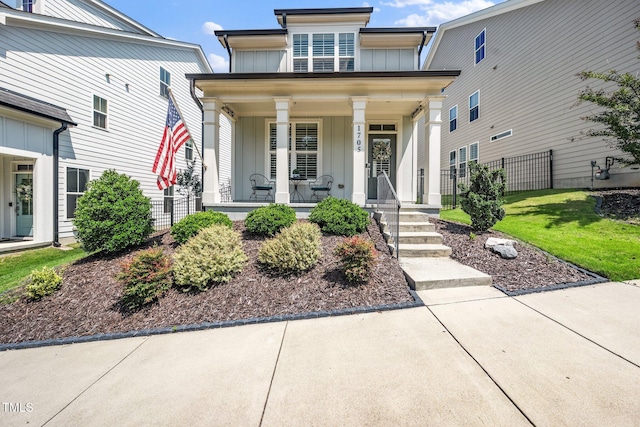 1705 Main Divide Dr, Wake Forest, NC 27587 - view of front of house featuring board and batten siding and covered porch